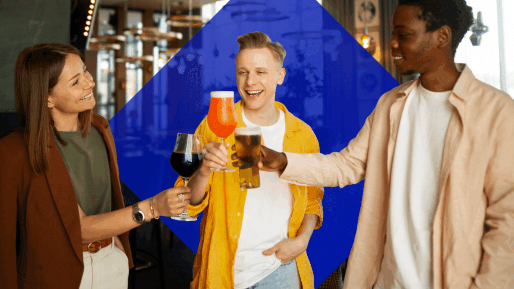 A woman holding a glass of wine cheers with a guy with a glass of cocktail and the other guy with beer