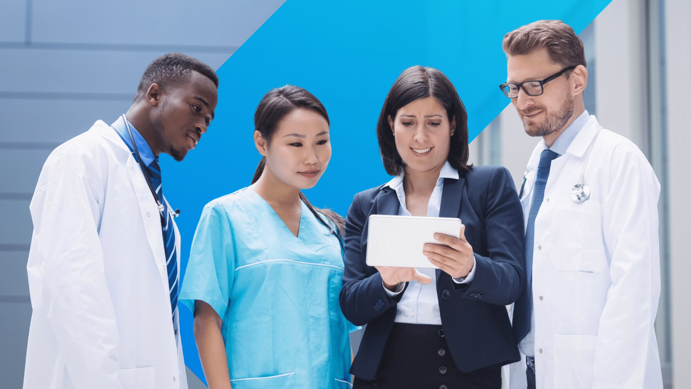 Healthcare professionals and academic leaders reviewing data on a tablet, symbolizing hospitals and academic medicine at the forefront of the GenAI revolution